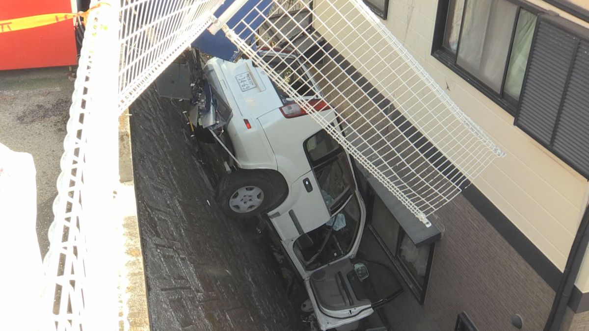 スーパーの駐車場で車がフェンスを突き破り隣接する住宅との隙間に転落 住宅の一部が壊れる