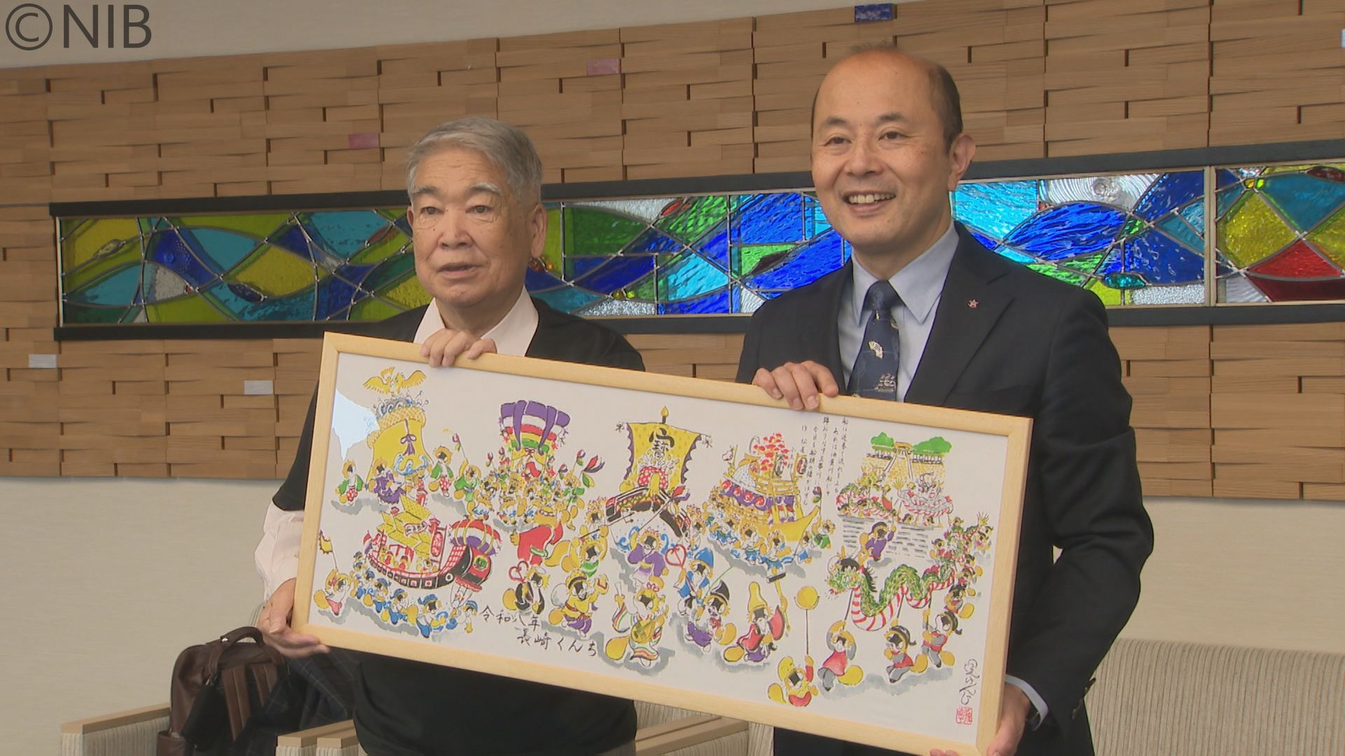 くんちの賑いを「たぬき絵」で表現 堤 けんじさんデザインの手ぬぐいを